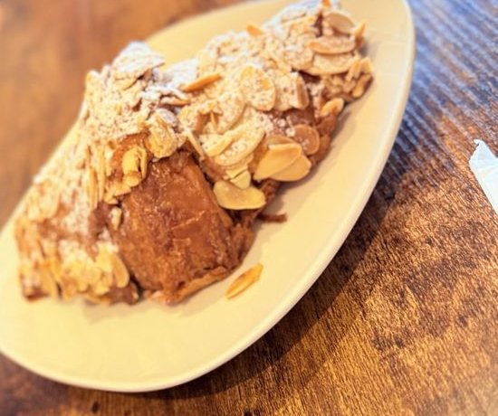 Almond croissant with sliced almonds on a plate